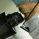 Qin Jinzhou, an embryologist who works at He Jiankui’s lab in Shenzhen, gazes through a microscope.